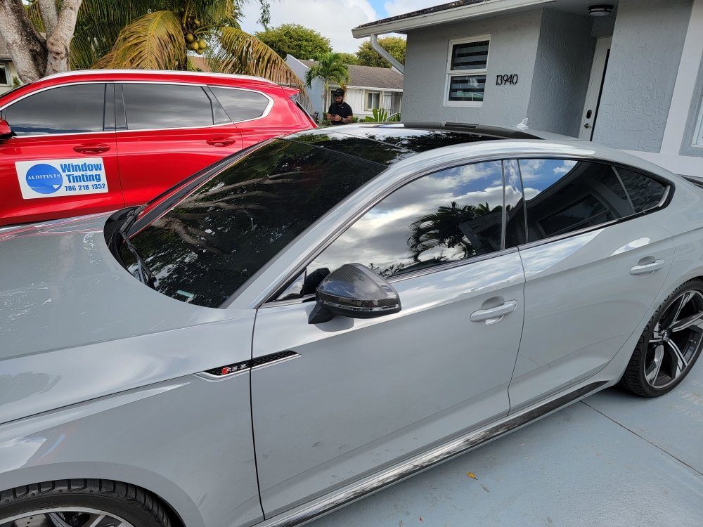 White Kia sedan tinted