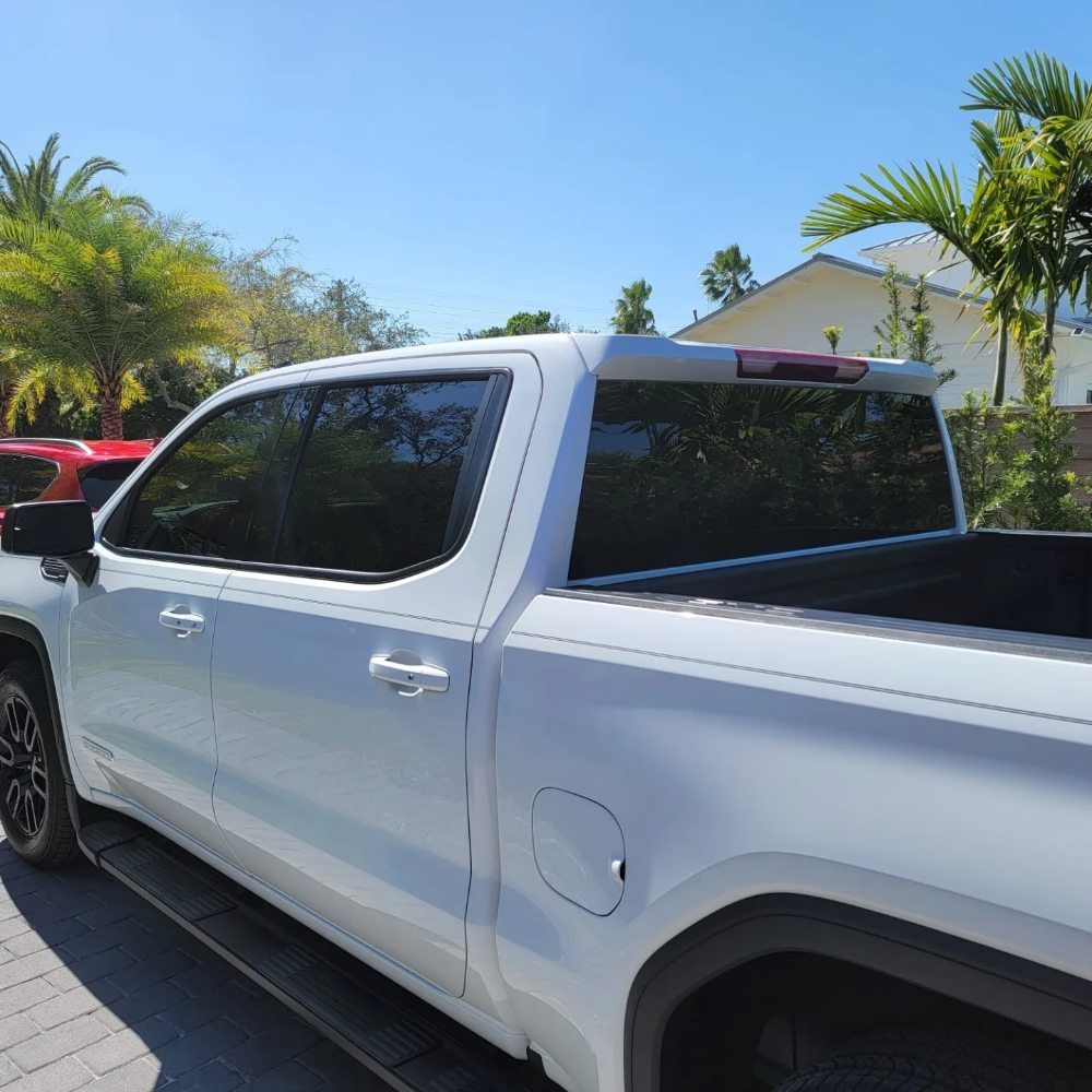 White pickup truck with tinted rear and side windows