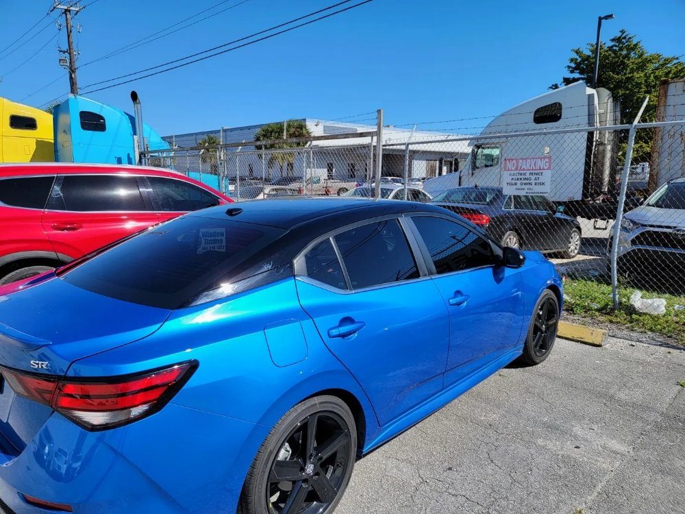 Electric blue Nissan Sentra with dark tint