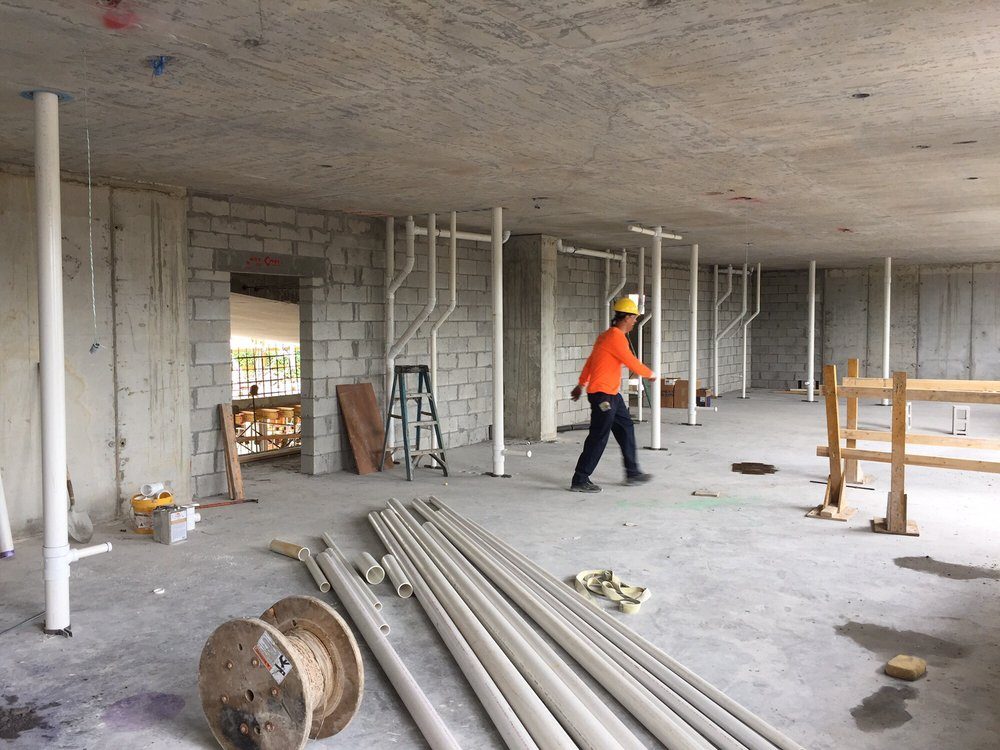 Plumbing rough-in on a commercial construction floor