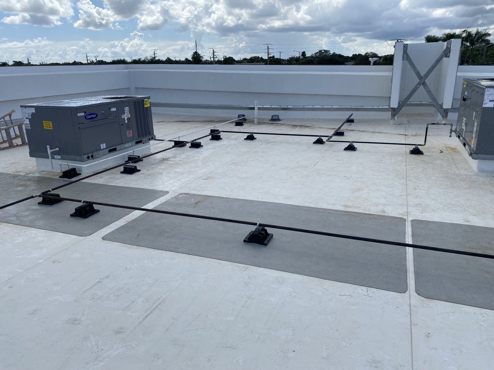 New gas piping run across a commercial rooftop to HVAC units