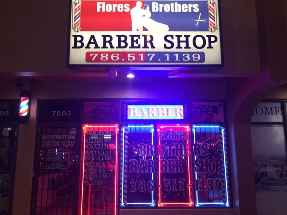 Flores Brothers Barber Shop storefront at night, neon sign on Coral Way