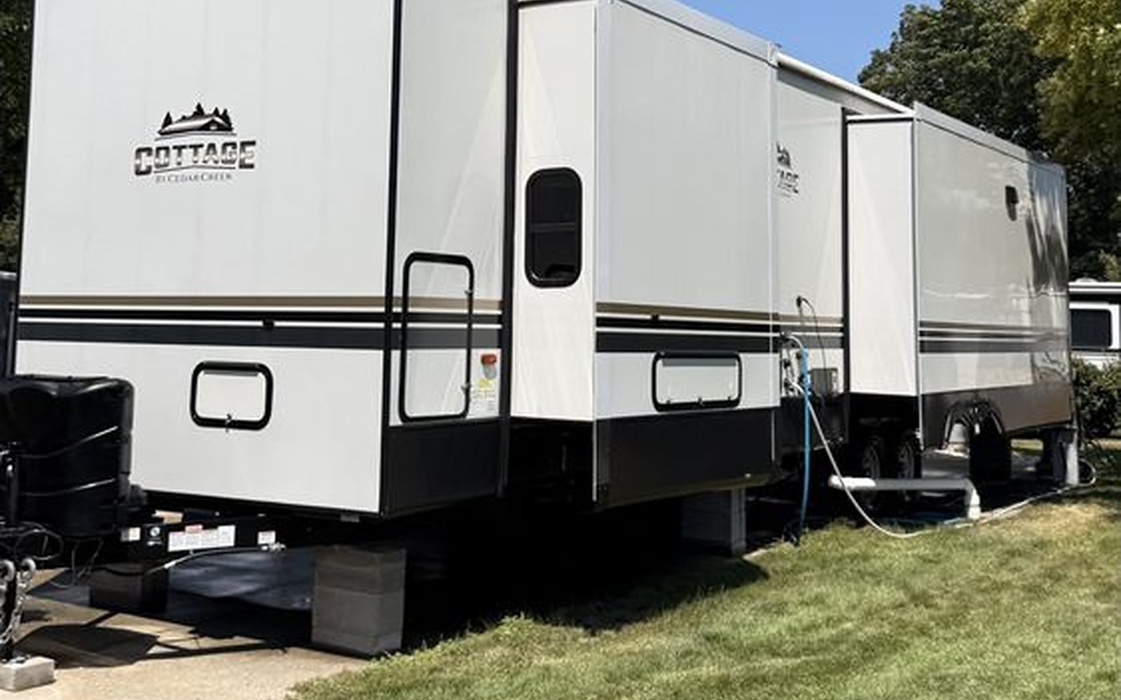 RV travel trailer on a lawn after an RV exterior detail