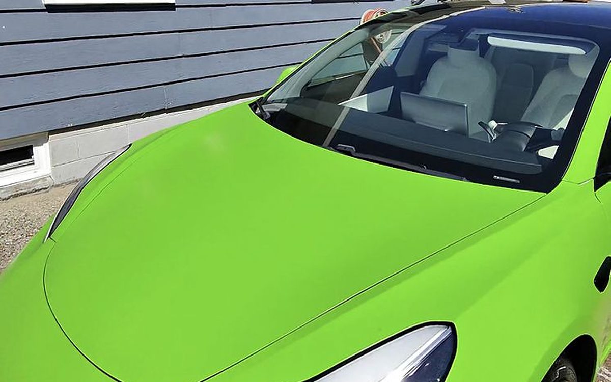 Lime-green Tesla Model 3 fender and headlight with deep gloss after a 10-year SunCoat Diamond ceramic coating