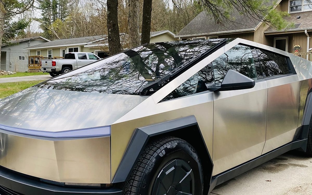 Silver Tesla Cybertruck side panels after XPEL paint protection film in a West Michigan driveway