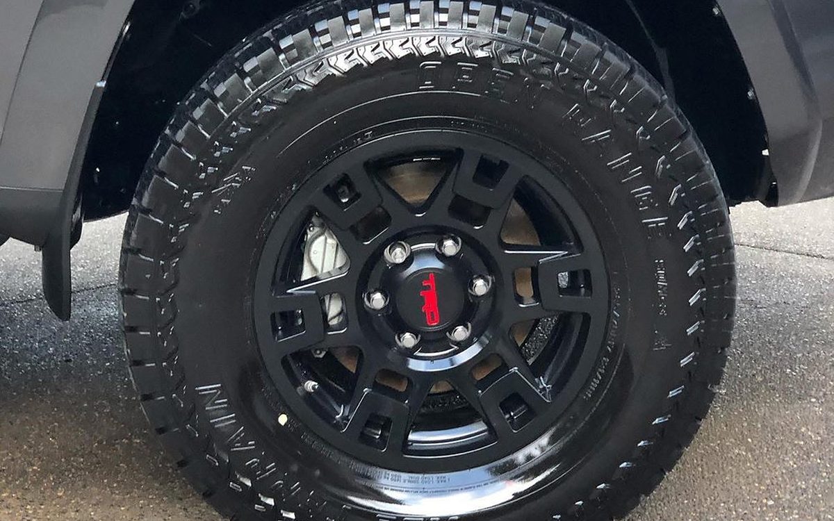 GMC all-terrain wheel and tire close-up after wheel ceramic coating and tire dressing