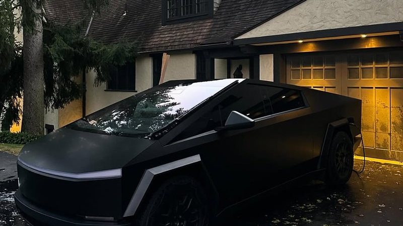 Matte-black Tesla Cybertruck in a customer’s driveway at dusk after ceramic coating