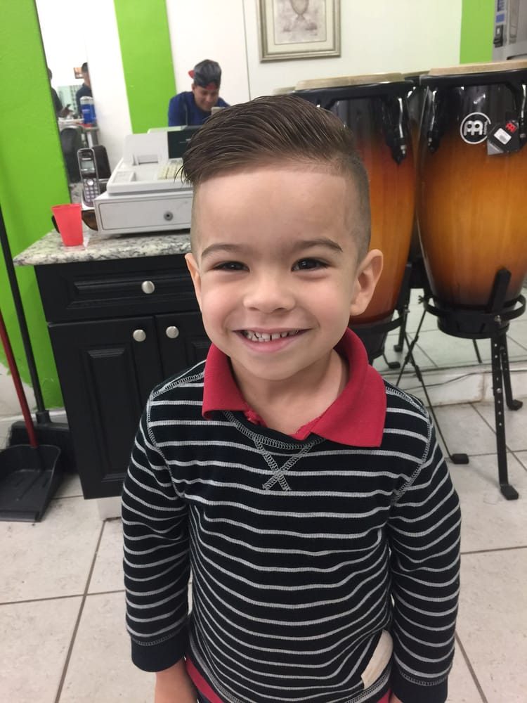 Kid smiling after his haircut