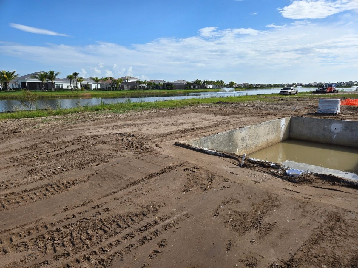 Backfilled and leveled yard next to a pool
