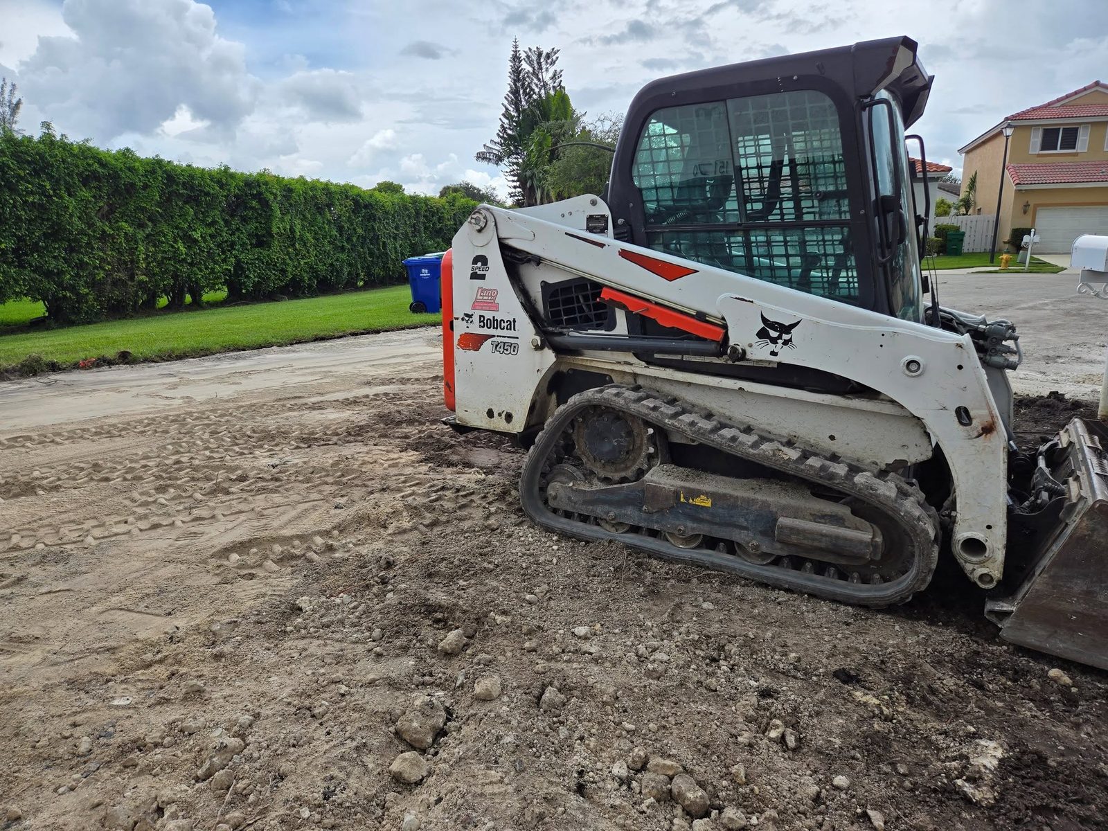 RWP's Bobcat T450 track loader on a residential driveway in Broward County