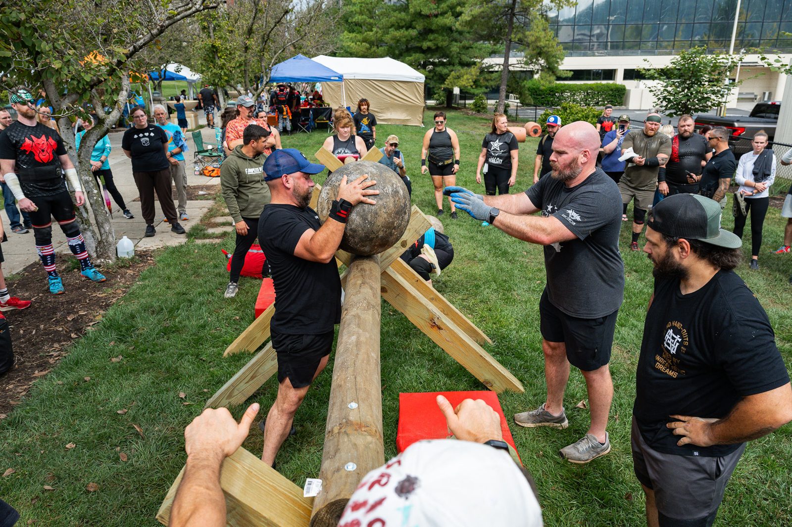 Athlete shouldering a natural stone in front of the crowd at Star City Strongman