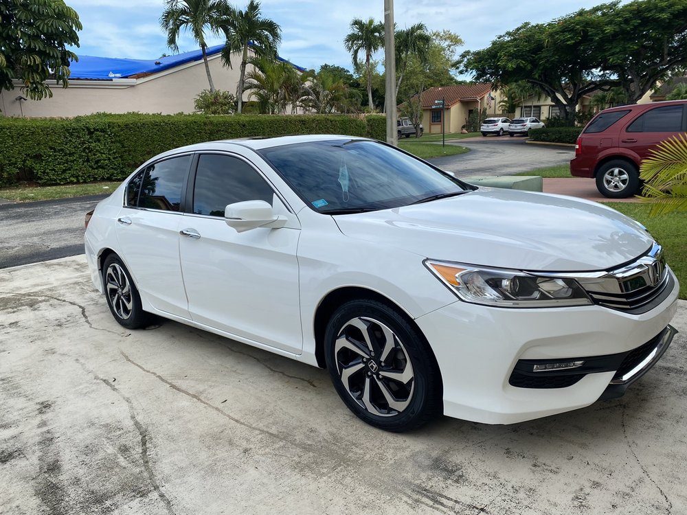 White Honda Accord freshly detailed by SunDaze in a Miami driveway