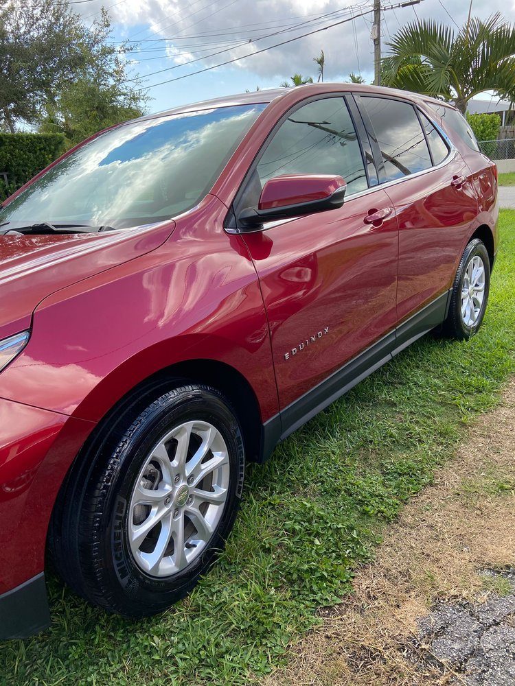 Red Chevy Equinox, side view, freshly waxed