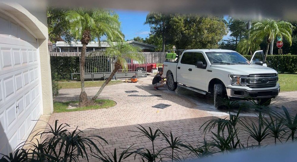 SunDaze working on a white Ford pickup in a driveway