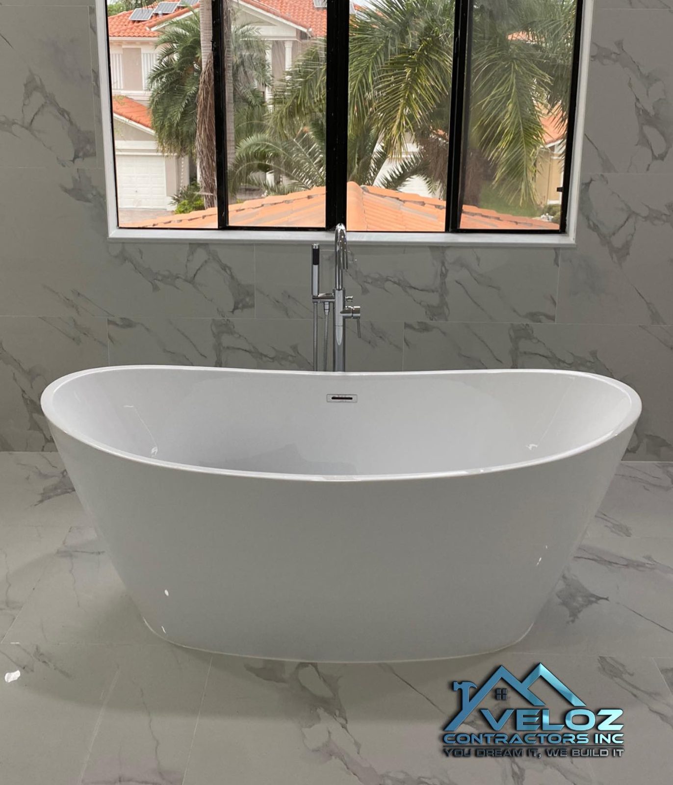 Bathroom remodel with freestanding tub and marble floor