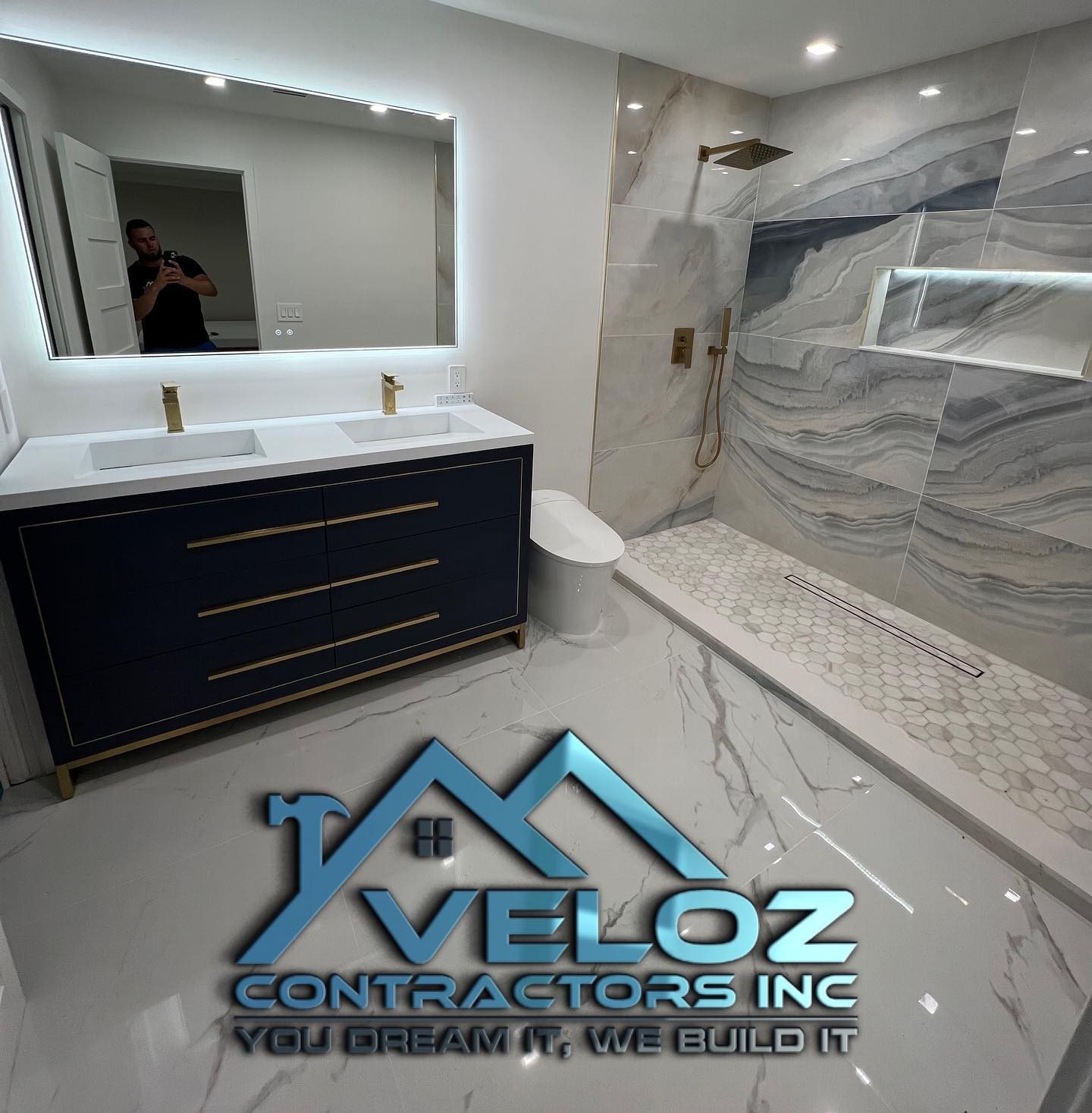 Navy vanity with marble shower wall