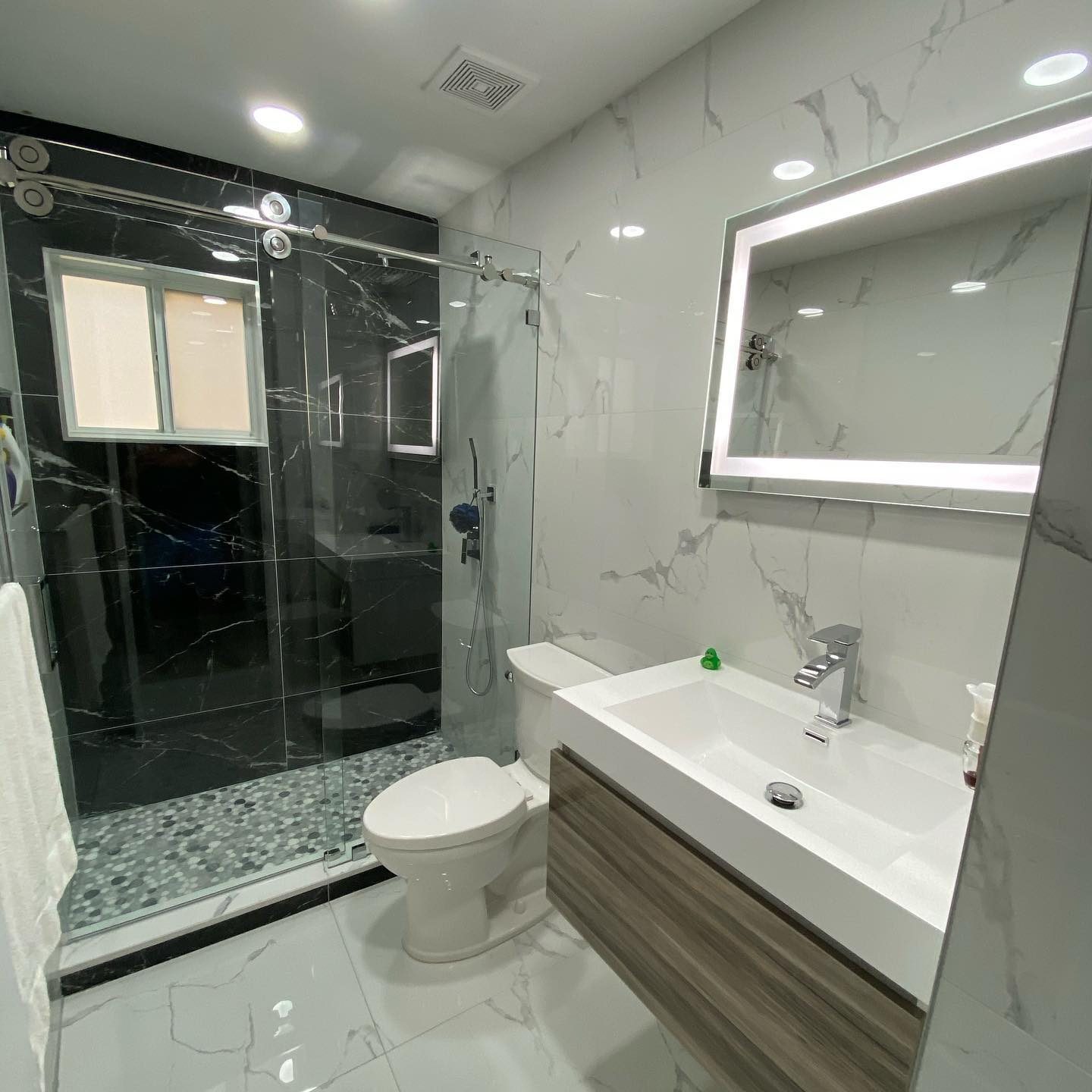 Black marble shower with LED mirror