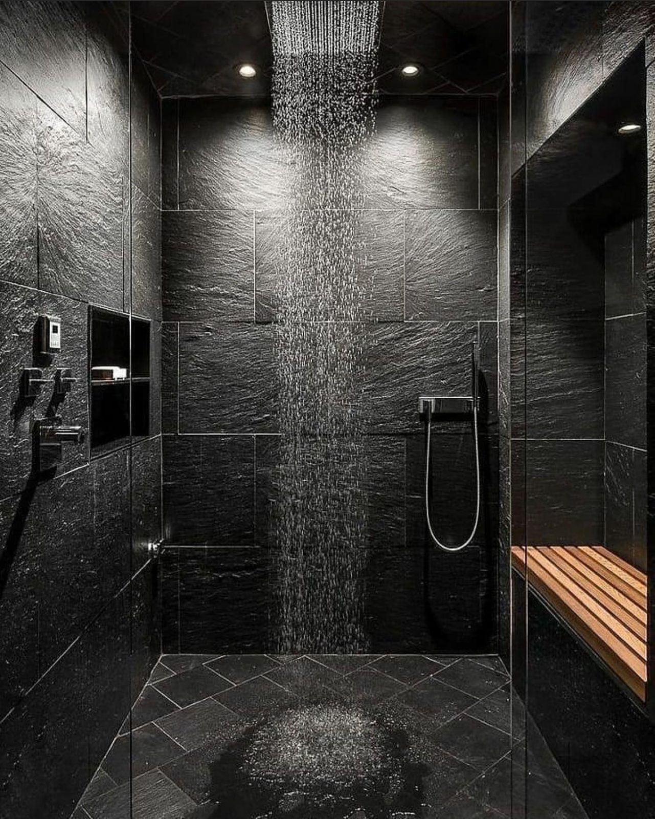 Black stone shower with teak bench