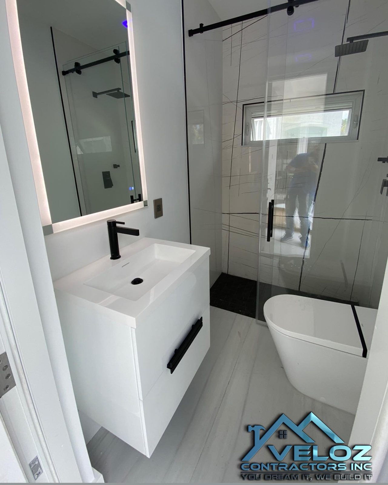 White bathroom with frameless glass shower