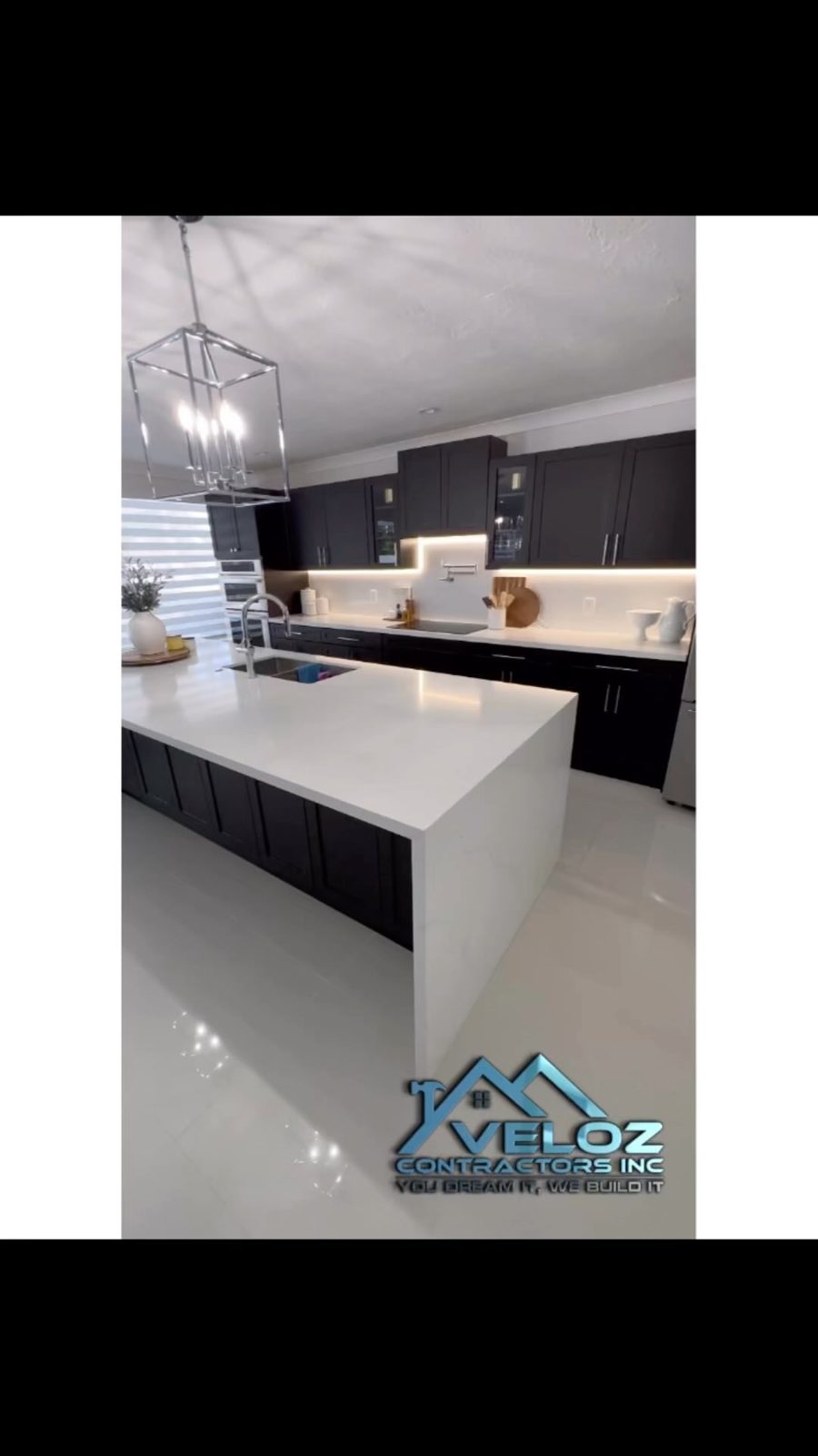 Kitchen with white island and pendant lights