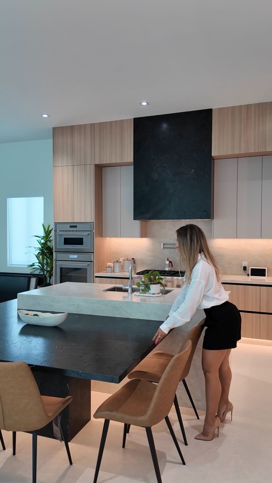 Modern kitchen remodel with dark island and oak cabinets