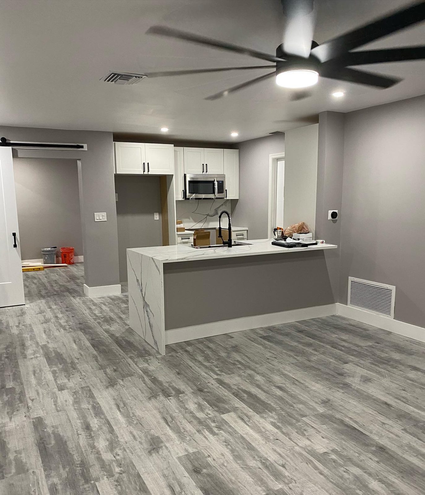 Open kitchen and living room remodel with wood-look floors