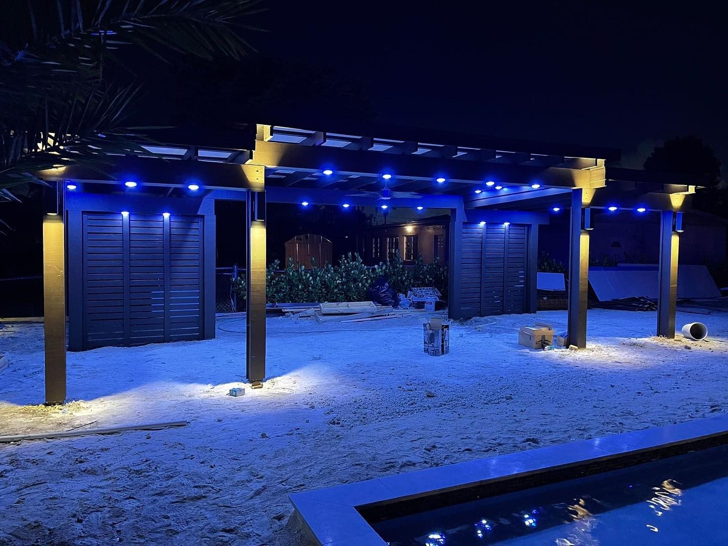 Backyard pergola with lighting at night