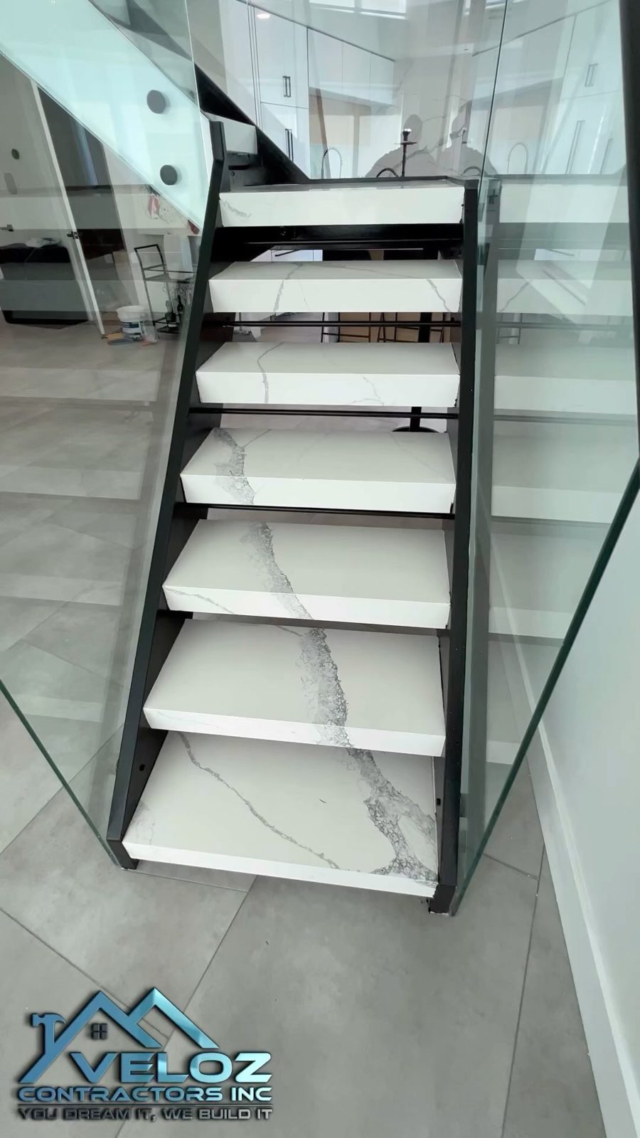 Marble staircase with black railing
