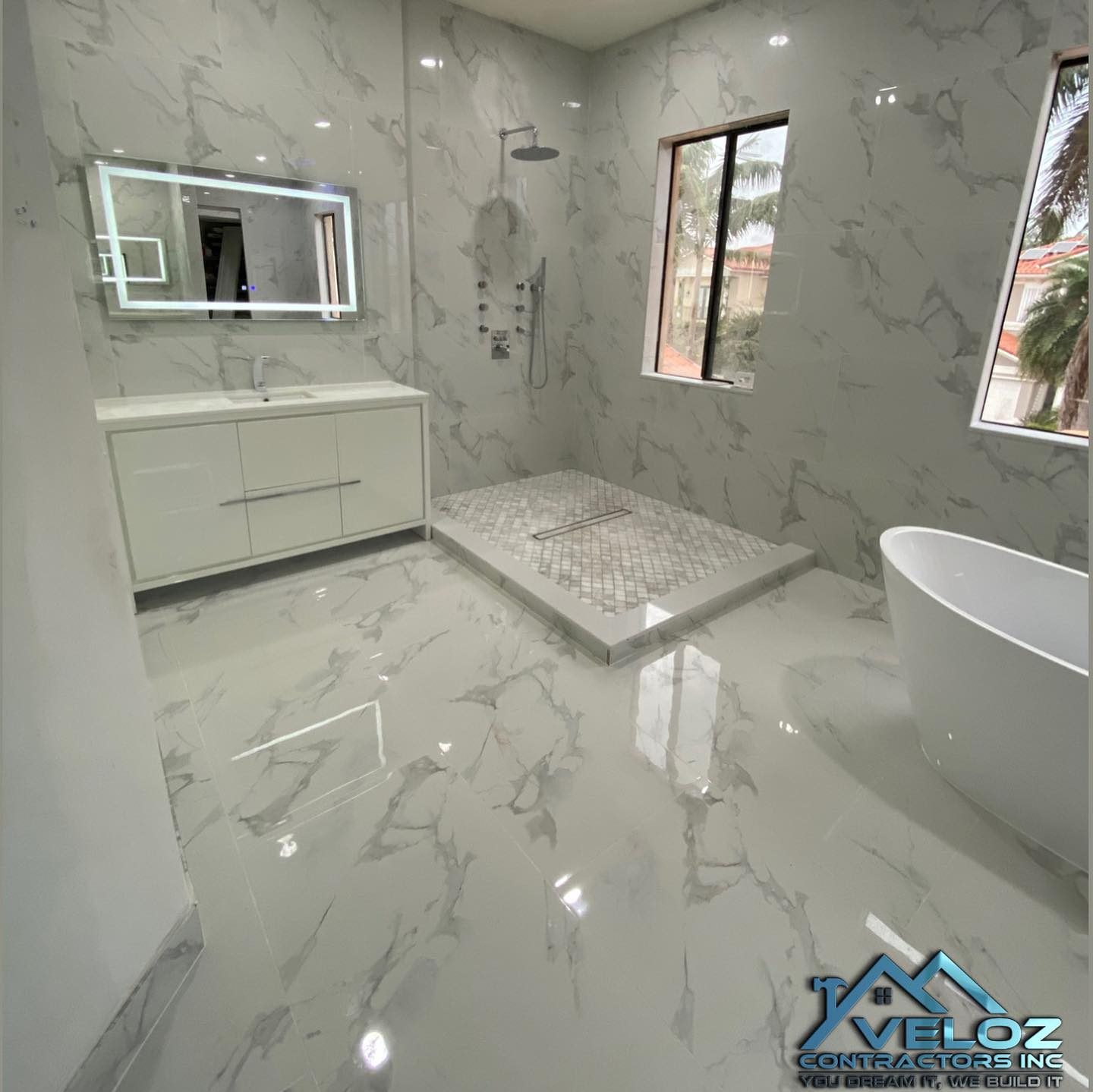 Bathroom with new black-frame windows and marble tile